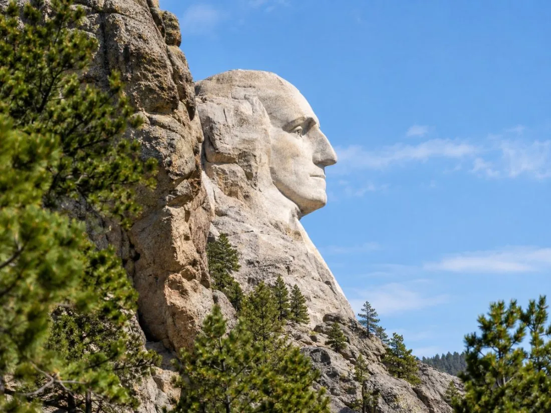 The profile of George Washington's carved face seen from a roadside pull-off